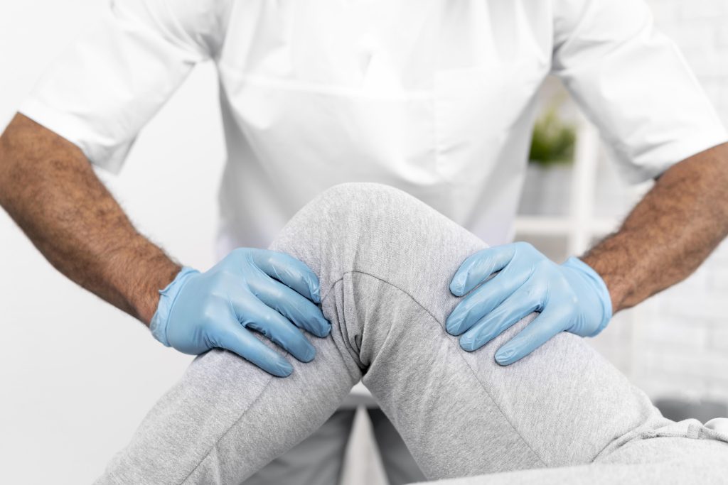 male physiotherapist checking woman s knee mobility KPM Physiotherapy